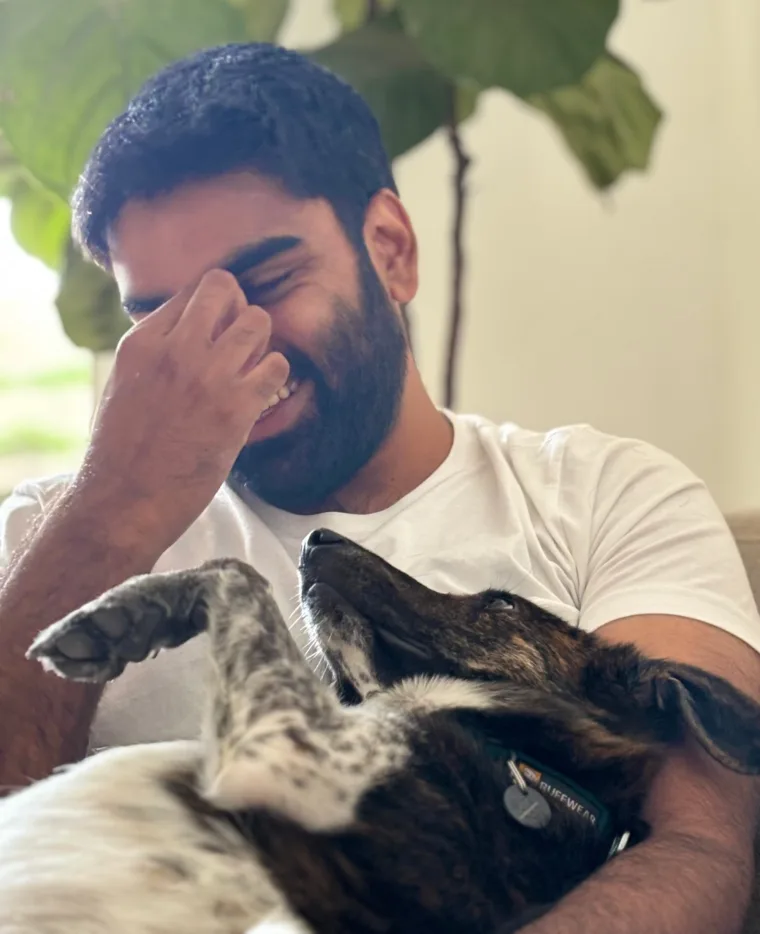 Ashwin smiling with his dog
